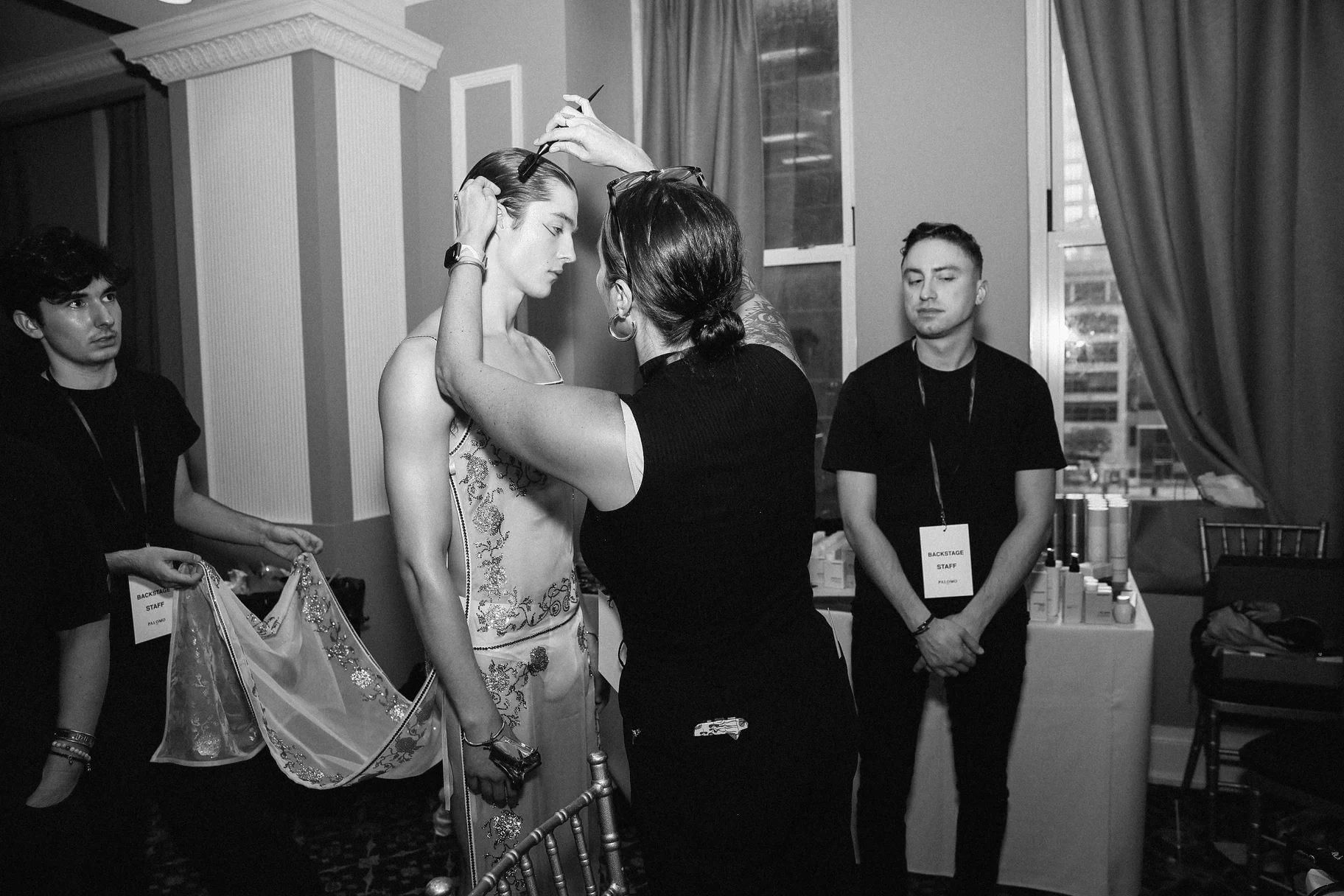 Palomo Spain — A model having a final adjustment made backstage